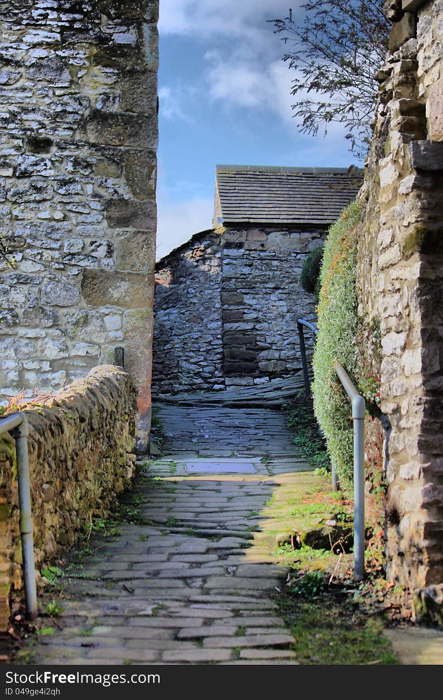 A steep alleyway through stone built buildings