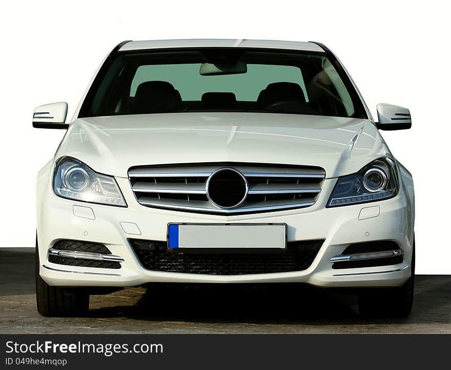 Front view of a luxury white vehicle isolated on a white background. Front view of a luxury white vehicle isolated on a white background