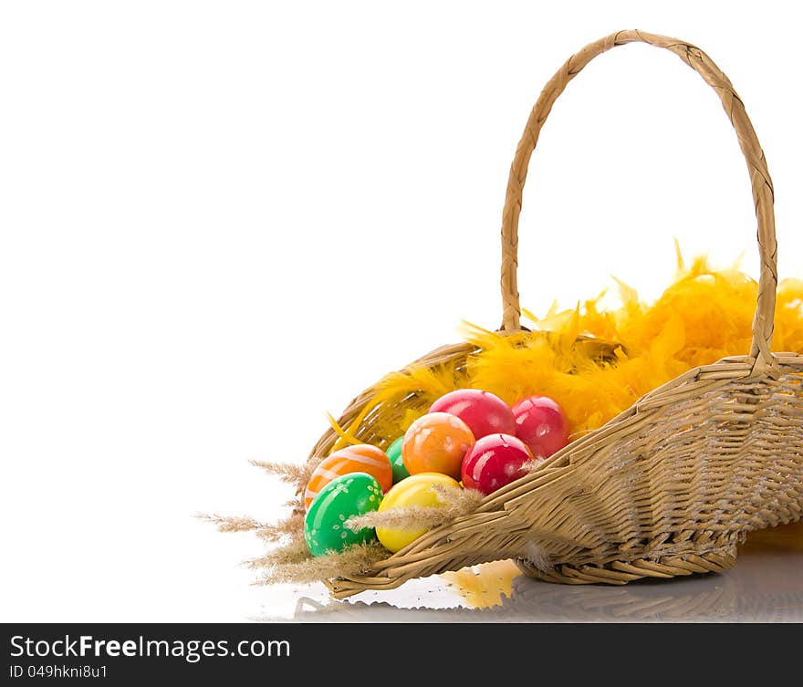 Basket with colorful Easter eggs on a white background. Basket with colorful Easter eggs on a white background