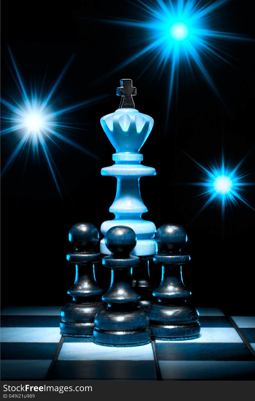 Chess (king and pawns) on a chess board. An art dark blue background. Chess (king and pawns) on a chess board. An art dark blue background.