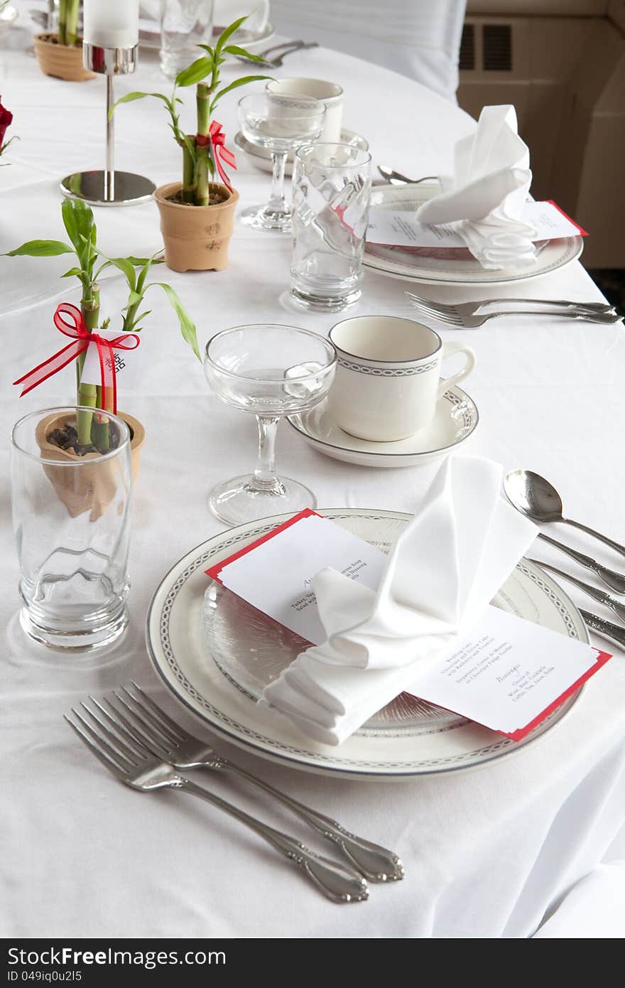 A wedding table set for fine dining with an Asian inspired theme and menu. A wedding table set for fine dining with an Asian inspired theme and menu