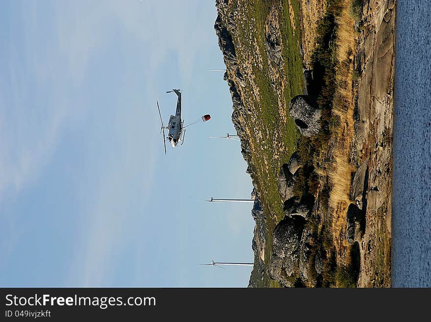 Firefighter helicopter in mission going to catch water