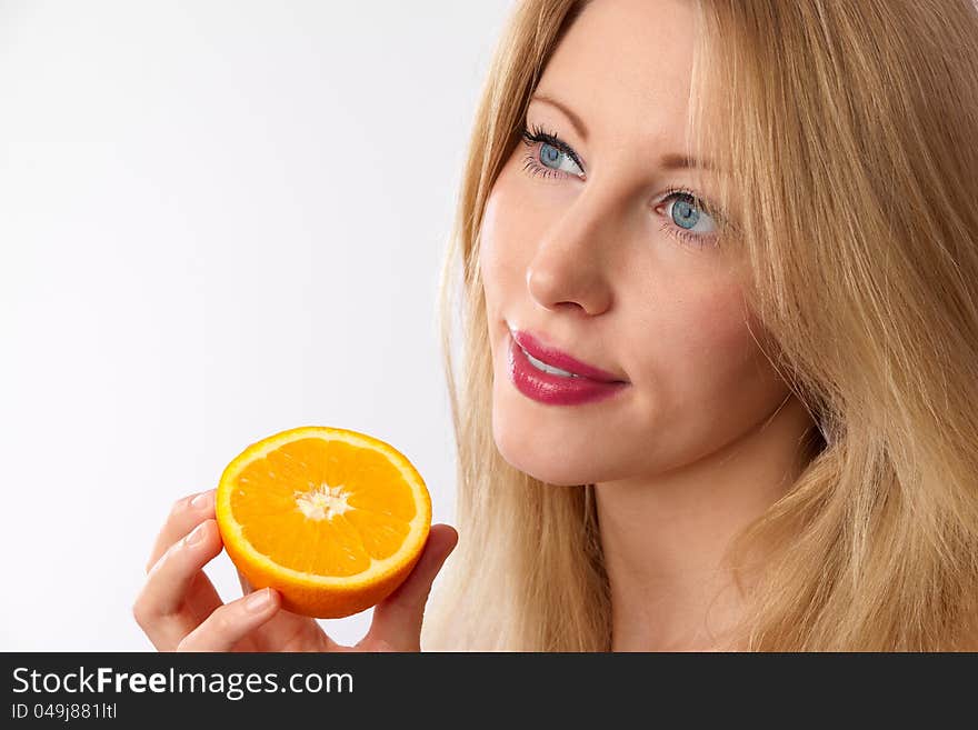 Caucasian woman holding orange