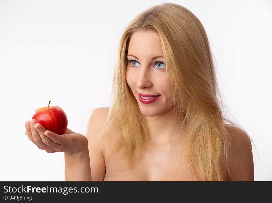 Closeup of young, blond, fit, beautiful and naked caucasian woman offering red apple. Closeup of young, blond, fit, beautiful and naked caucasian woman offering red apple