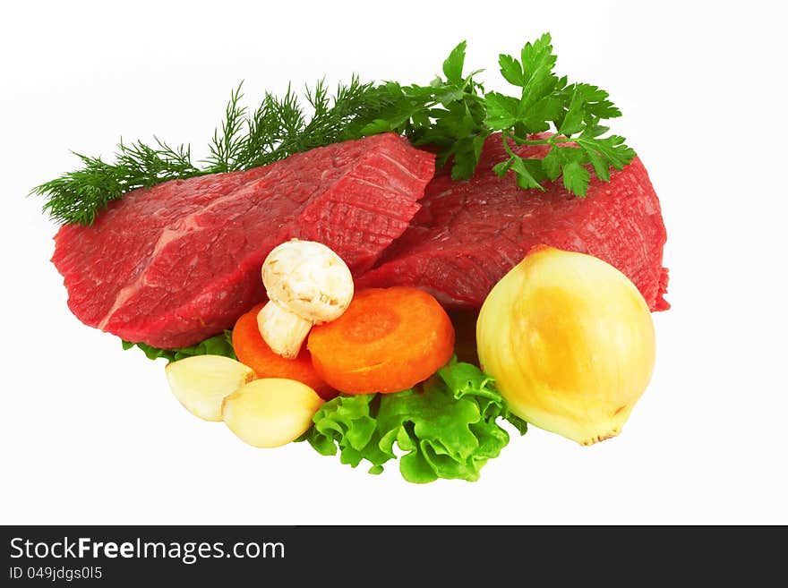 Raw meat and vegetables on white