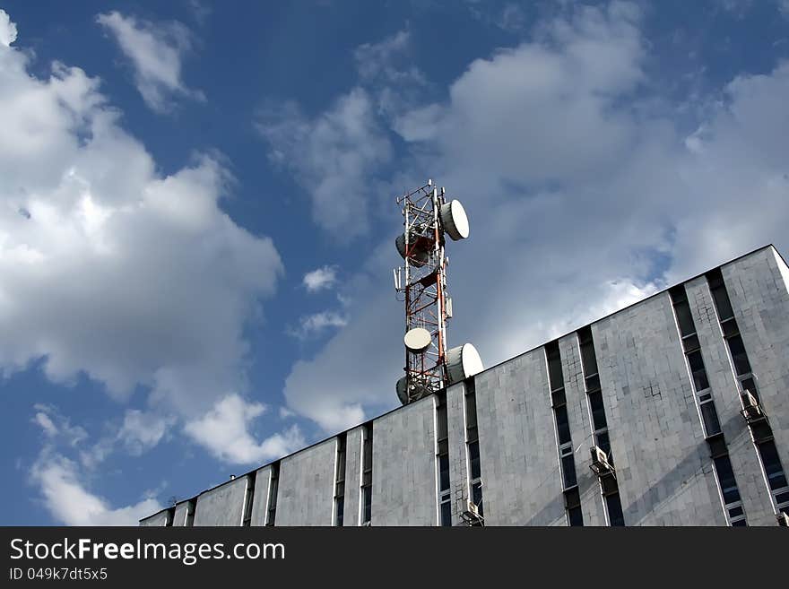 Radio, television ,telephone - antenna . Background -  cloudy sky. Radio, television ,telephone - antenna . Background -  cloudy sky