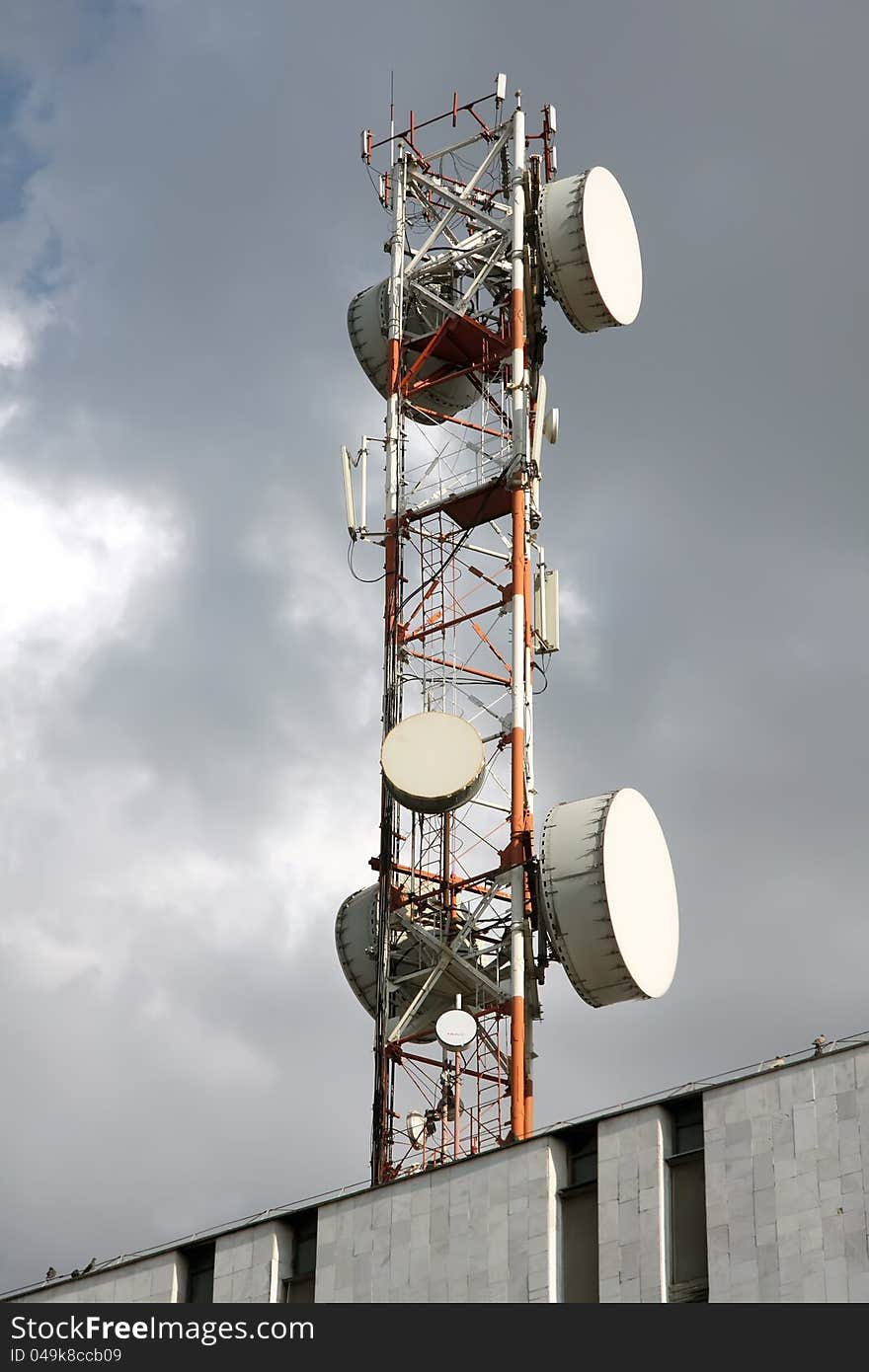 Radio, television ,telephone - antenna . Background -  cloudy sky. Radio, television ,telephone - antenna . Background -  cloudy sky