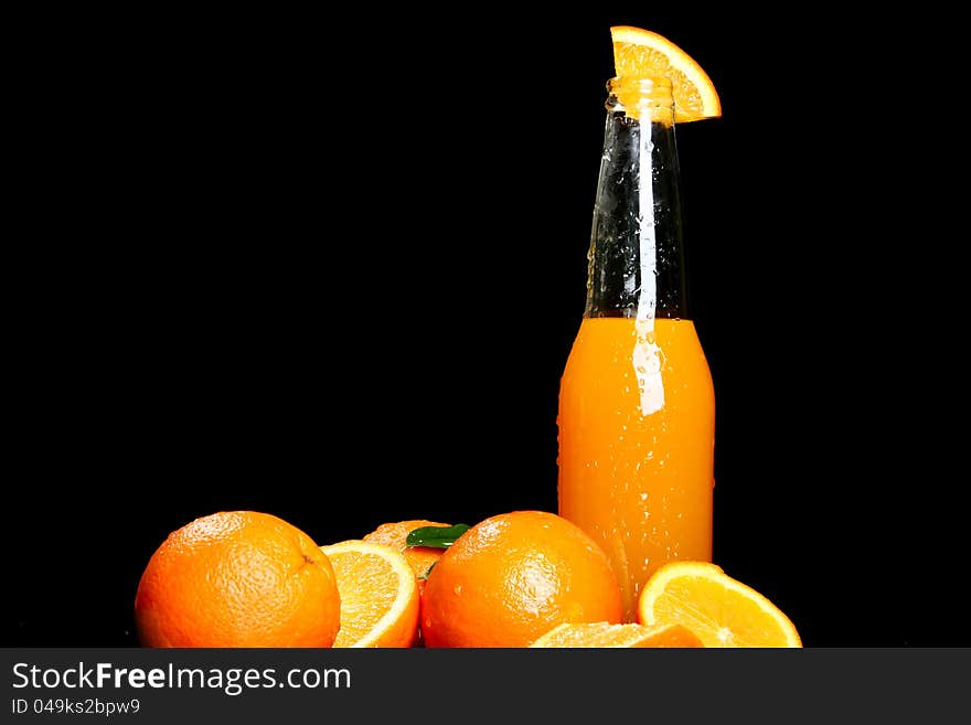 Fresh orange drink over black background