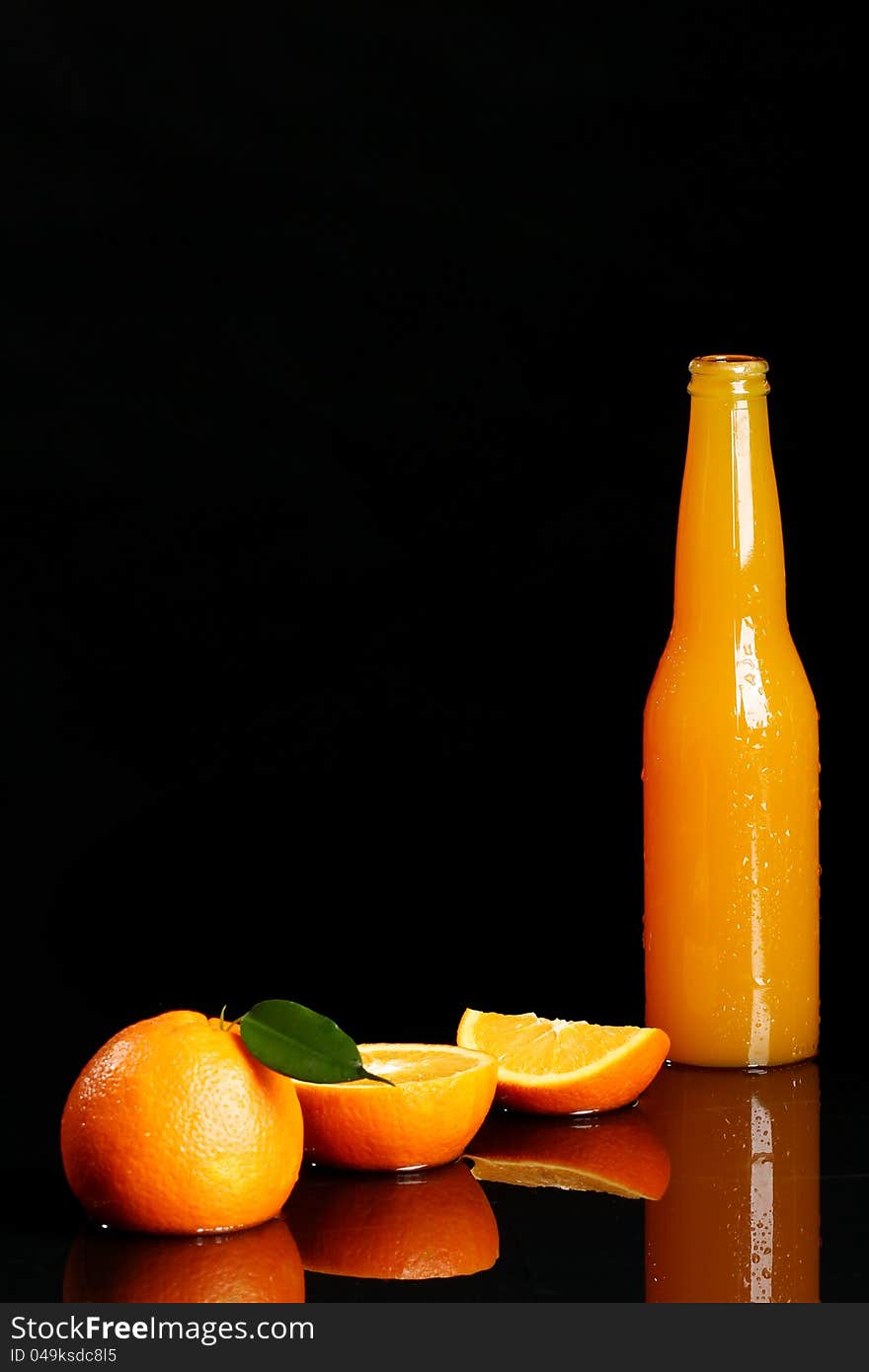 Fresh orange drink over black background