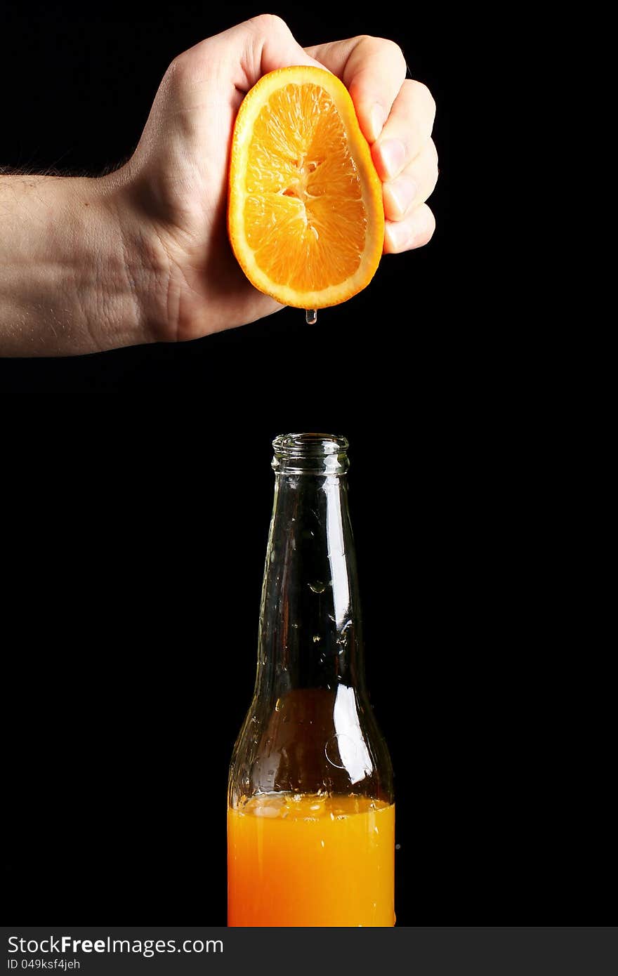 Fresh squezeed orange juice over black background