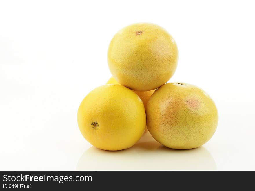 A stack of fresh whole grapefruits