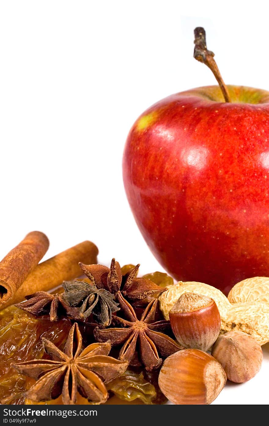 Apple, raisins, nuts and cinnamon on a white background. Apple, raisins, nuts and cinnamon on a white background