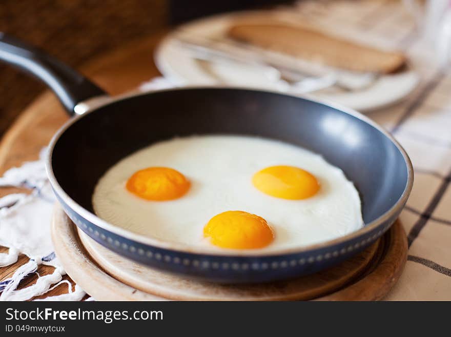 Frying pan with three fried eggs