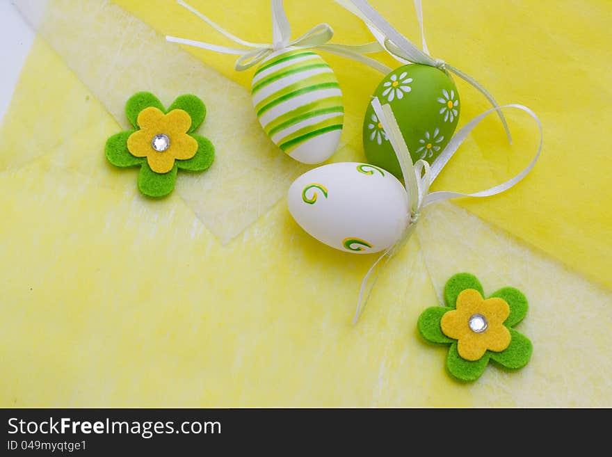 Colorful Easter eggs on a yellow background