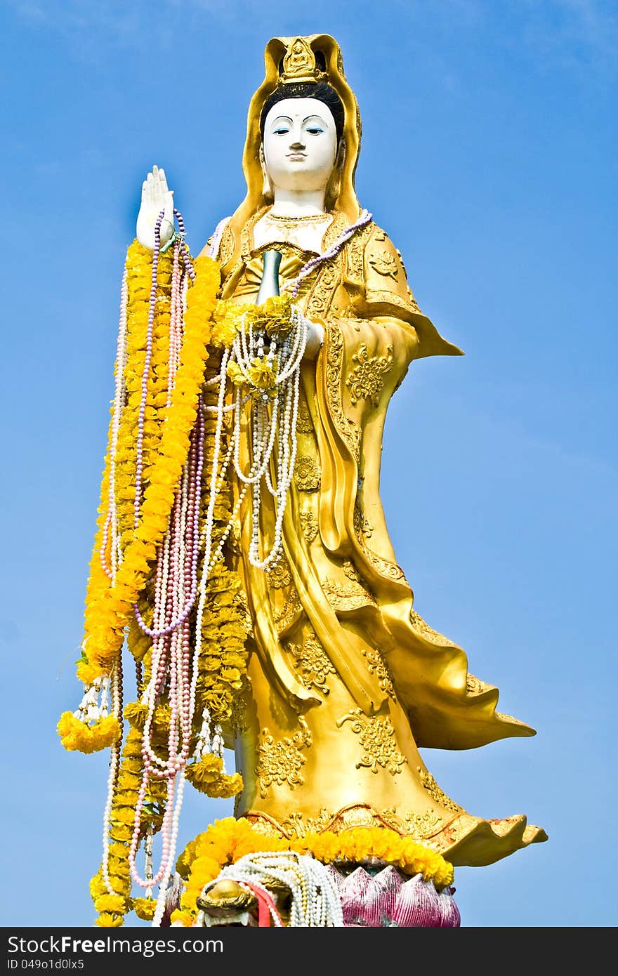 Gold kwan yin on blue sky