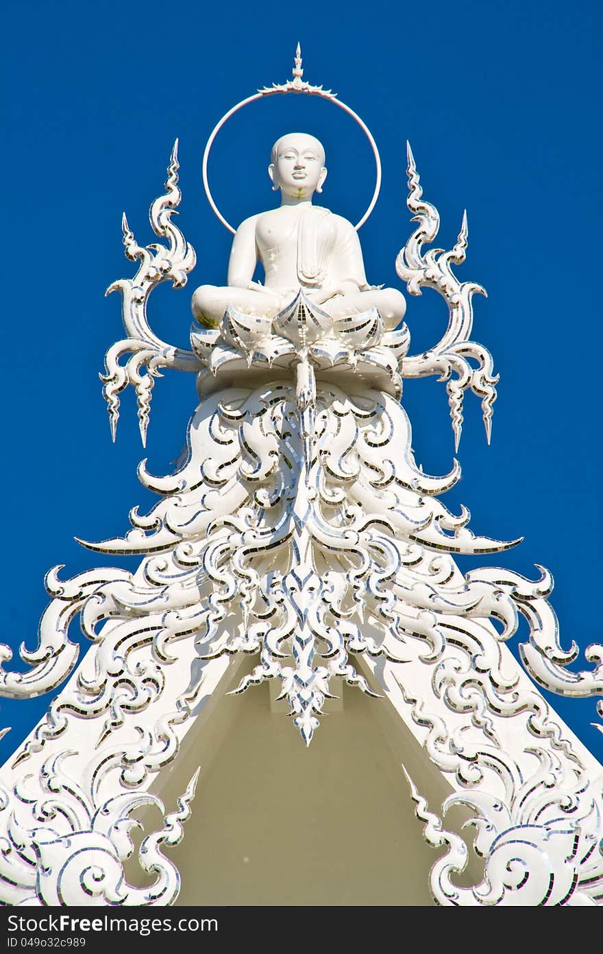 buddha on top of white chruch