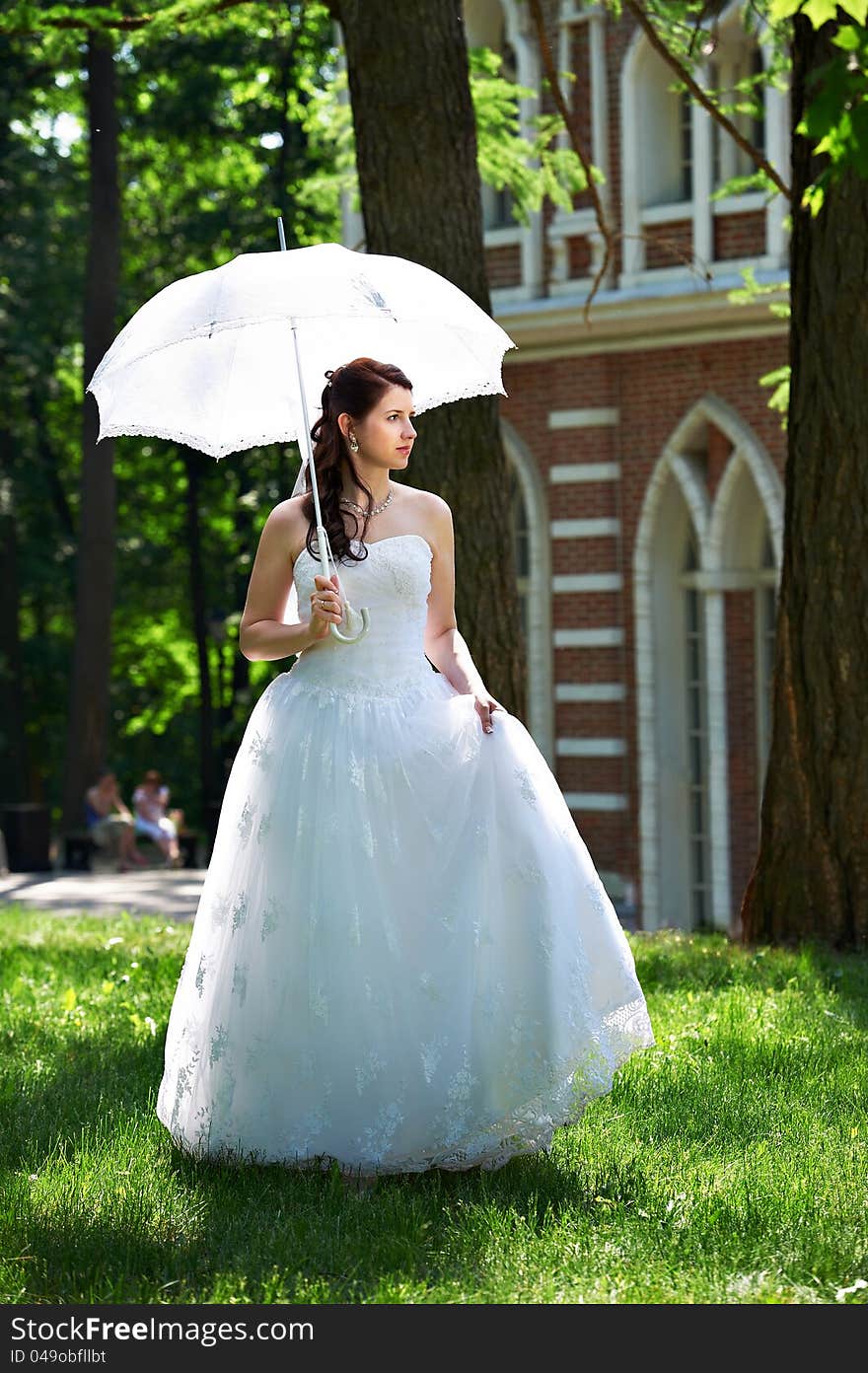 Happy bride in park in wedding walk. Happy bride in park in wedding walk