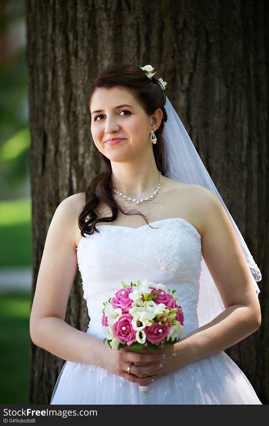 Happy bride with bouquet in wedding walk