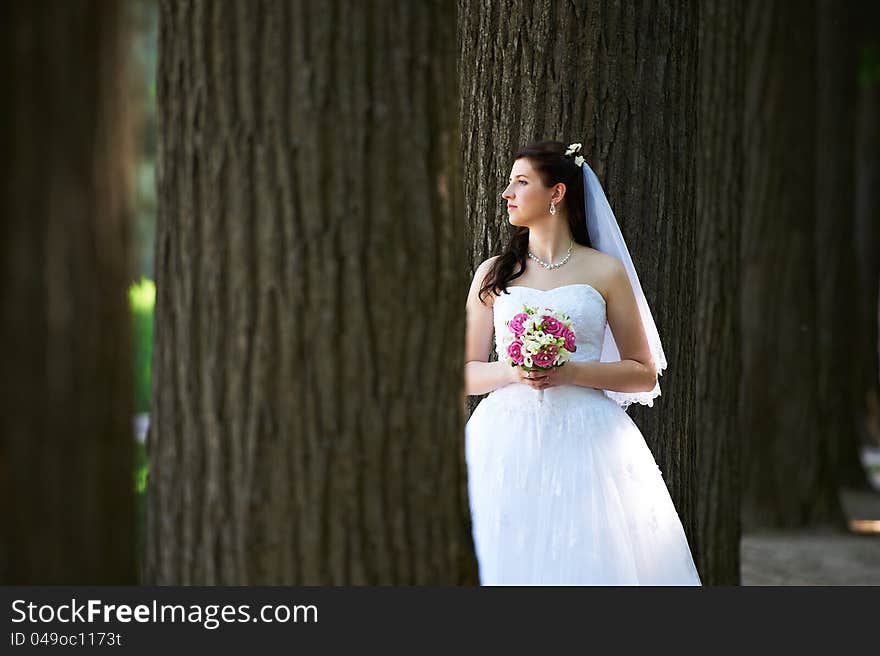 Happy bride with bouquet in wedding walk