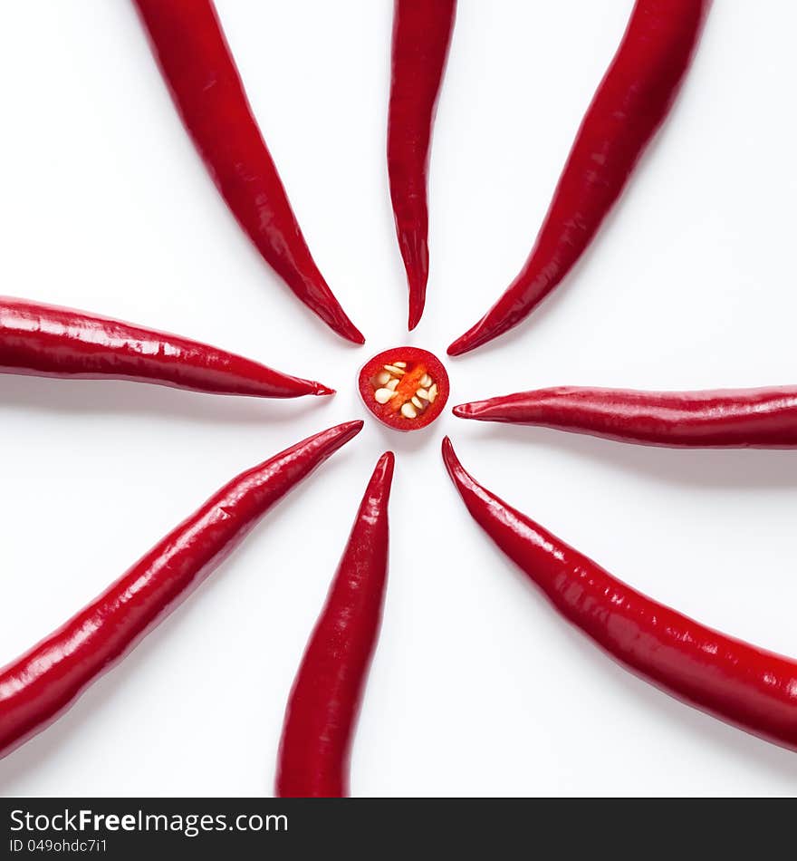 Red chili peppers arranged in a circle, isolated on white background