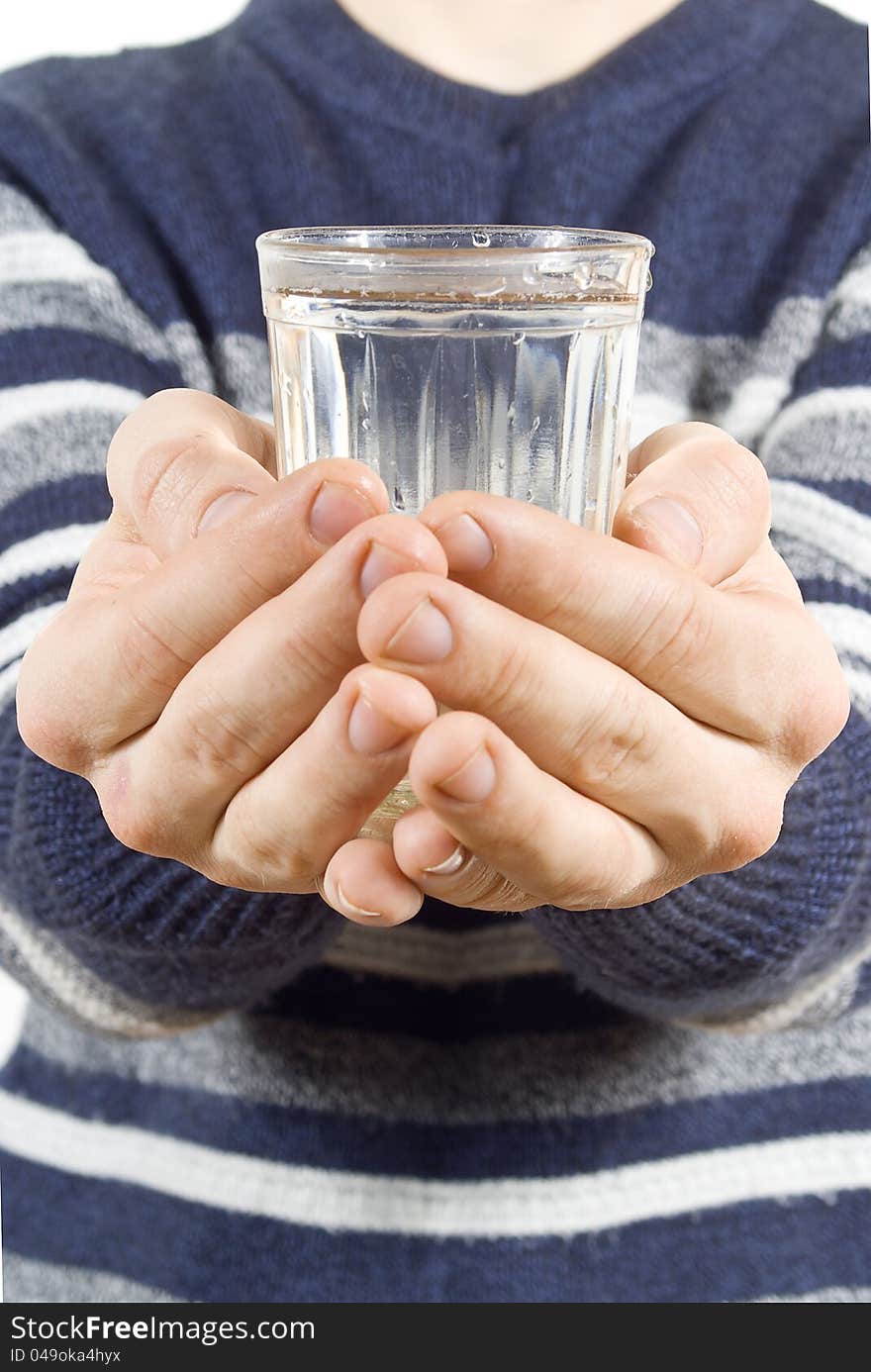 Hands holding a glass of water isolated on white background