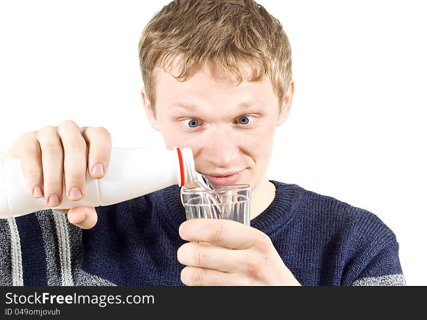 The guy pours water into a glass of isolated on white background