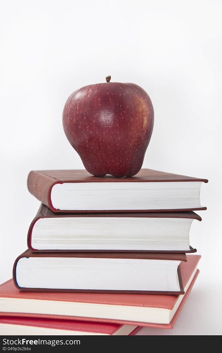 Pile of books with apple