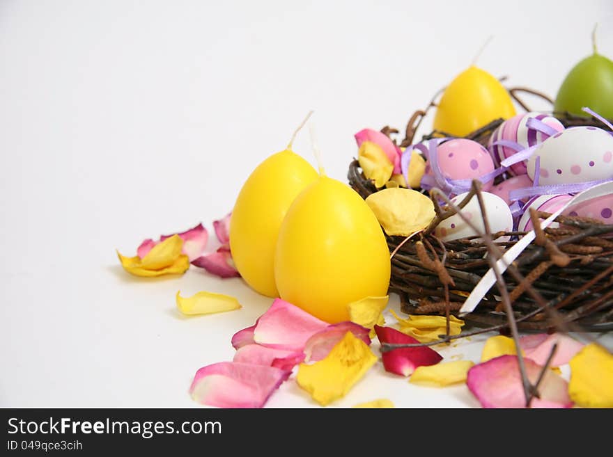 Multicolored Easter eggs in a nest and wicker basket. Multicolored Easter eggs in a nest and wicker basket