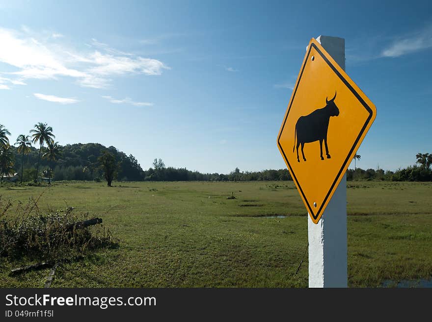 Animal warning sign on the green field