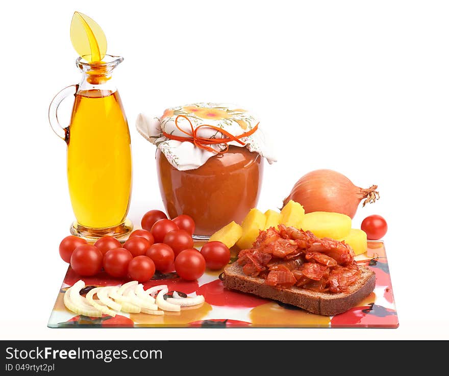 Still life with home canning jar of vegetable caviar and bottle of vegetable oil, cherry 
tomatoes, onion and potato. Still life with home canning jar of vegetable caviar and bottle of vegetable oil, cherry 
tomatoes, onion and potato.