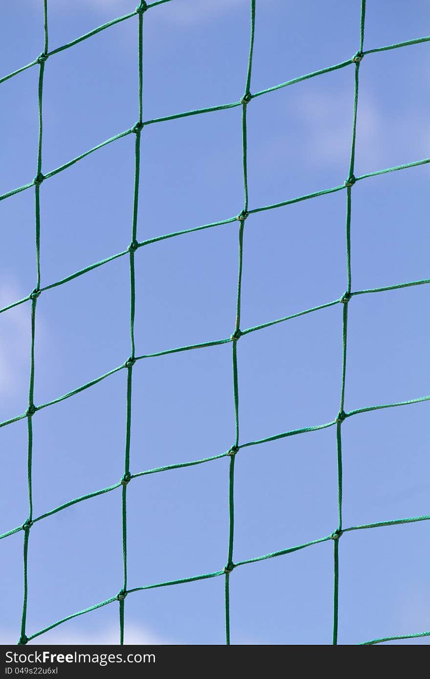 Partial view of a beach ball net field over a blue sky.