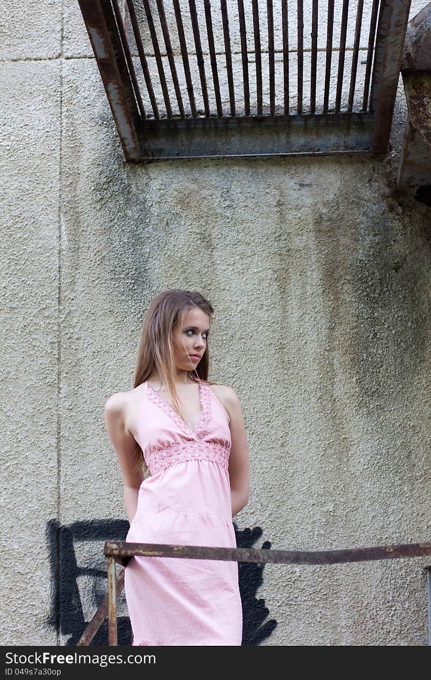 Young girl standing on old stairs