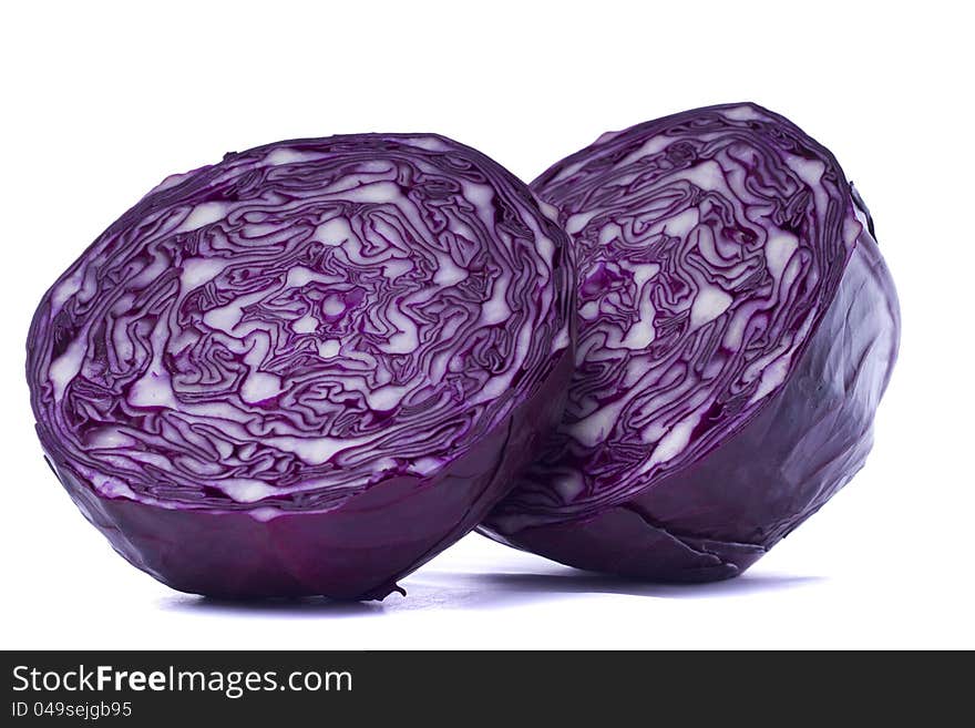 Close view of a sliced red cabbage isolated on a white background.