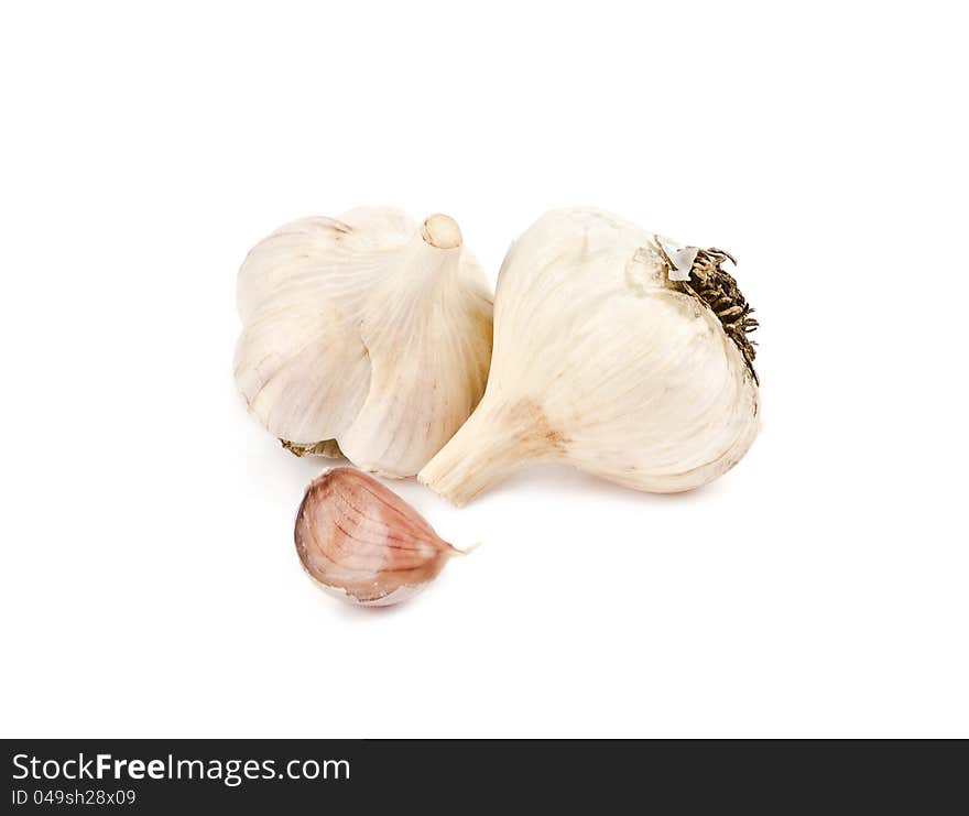 Two heads of garlic and clove on a white background