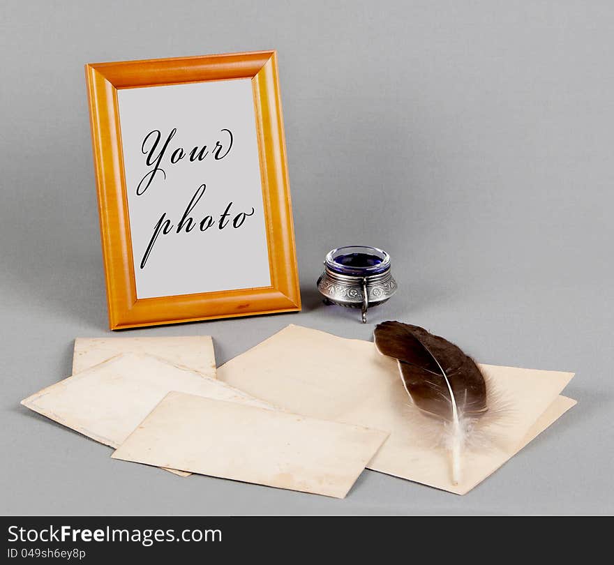 Wooden frame and old photo, feather and inks