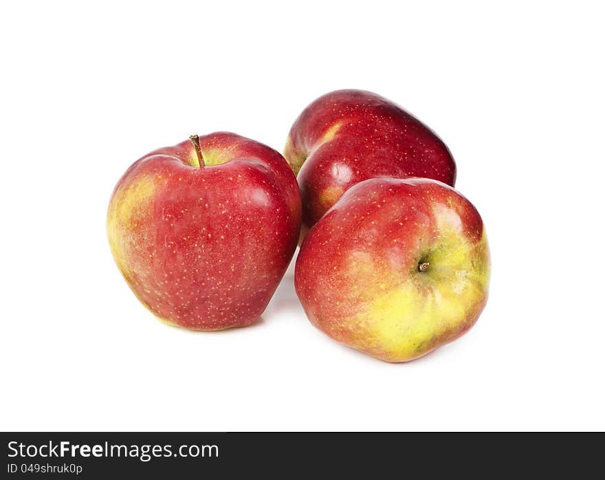 Three red apples on a white background