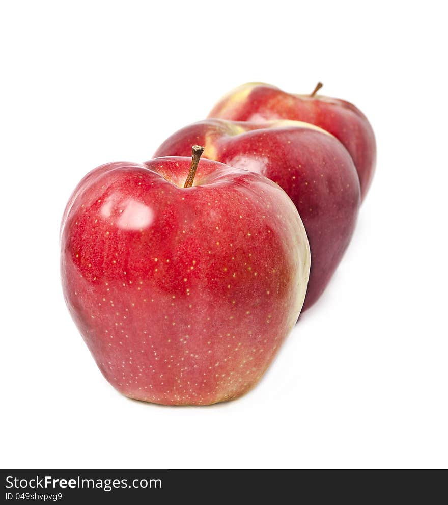 Three red apples on a white background