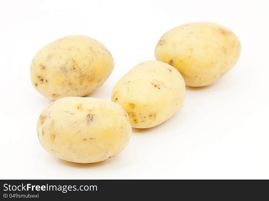 New potatoes and fresh on a white background. New potatoes and fresh on a white background