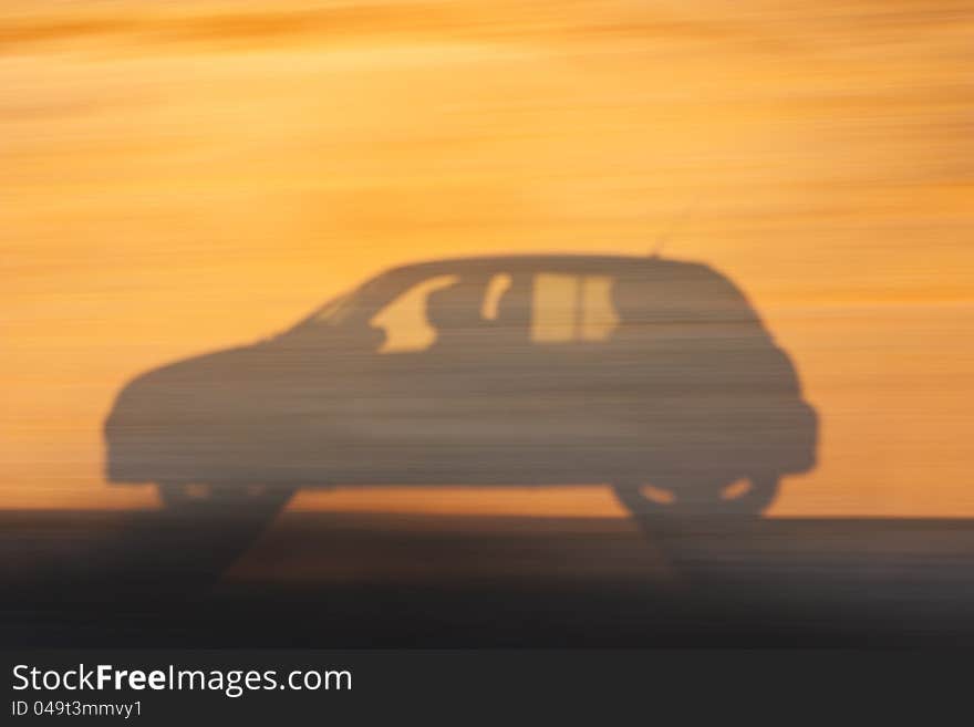 Shadow of a moving car on the slope of the road