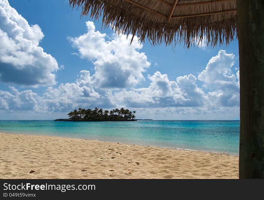 Paraise beach and a small island in summertime. Paraise beach and a small island in summertime