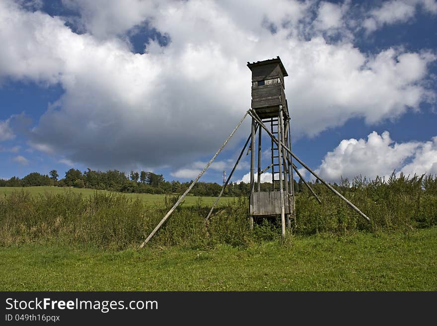 Wooden shelter for hunters on the green between