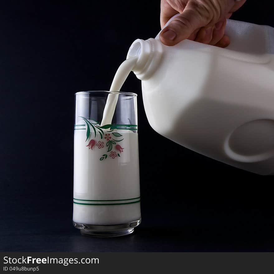 Pouring a nice cold glass of Milk. Pouring a nice cold glass of Milk.