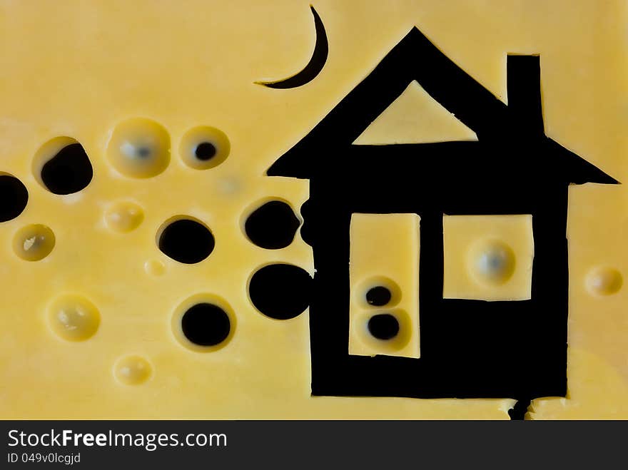 Picture of house frome sliced cheese on black background