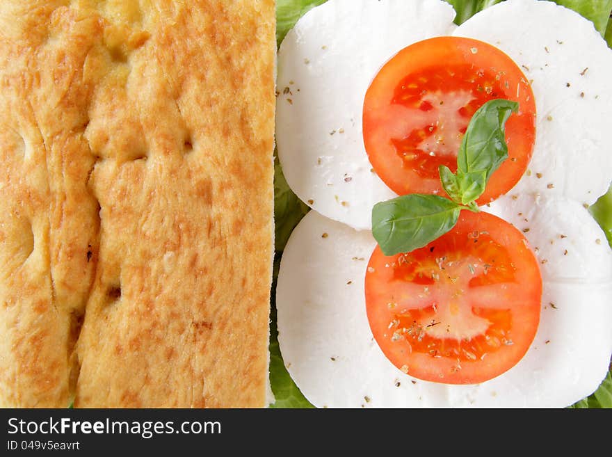 Closeup focaccia whit caprese tomato end mzzarella. Closeup focaccia whit caprese tomato end mzzarella