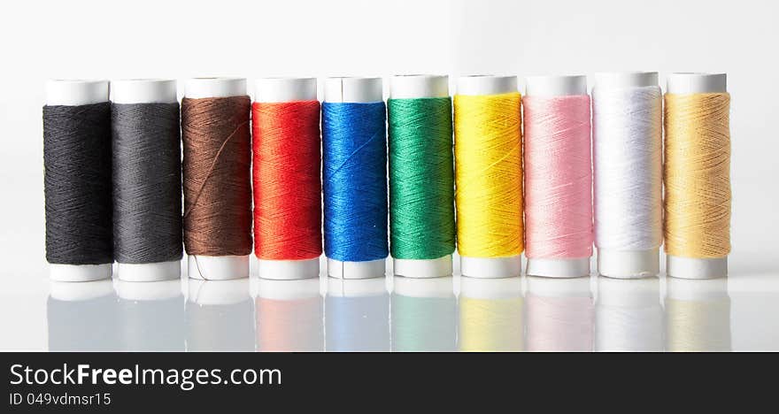 Colorful bobbins on a white background