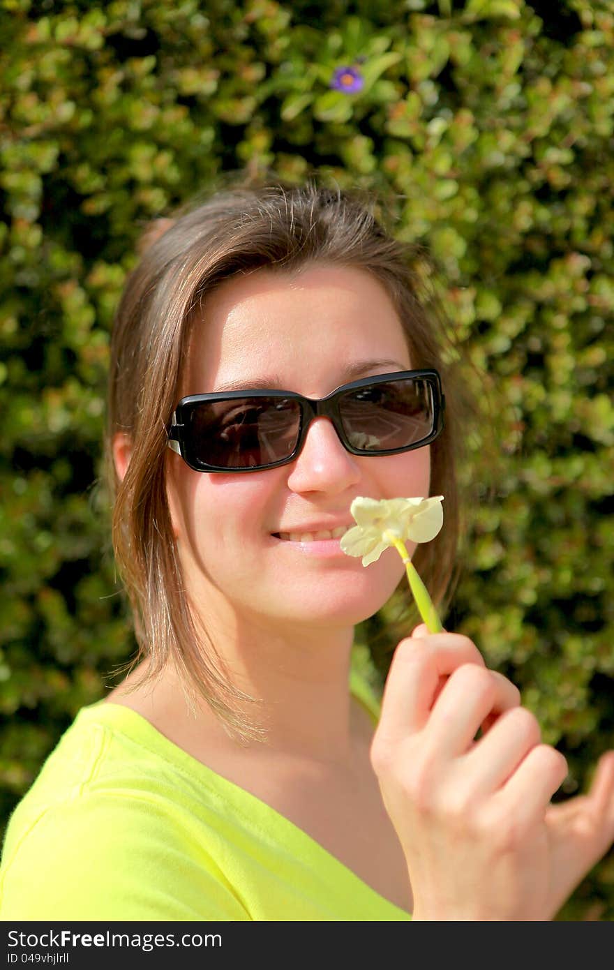 Portrait of a girl in glasses with a flower