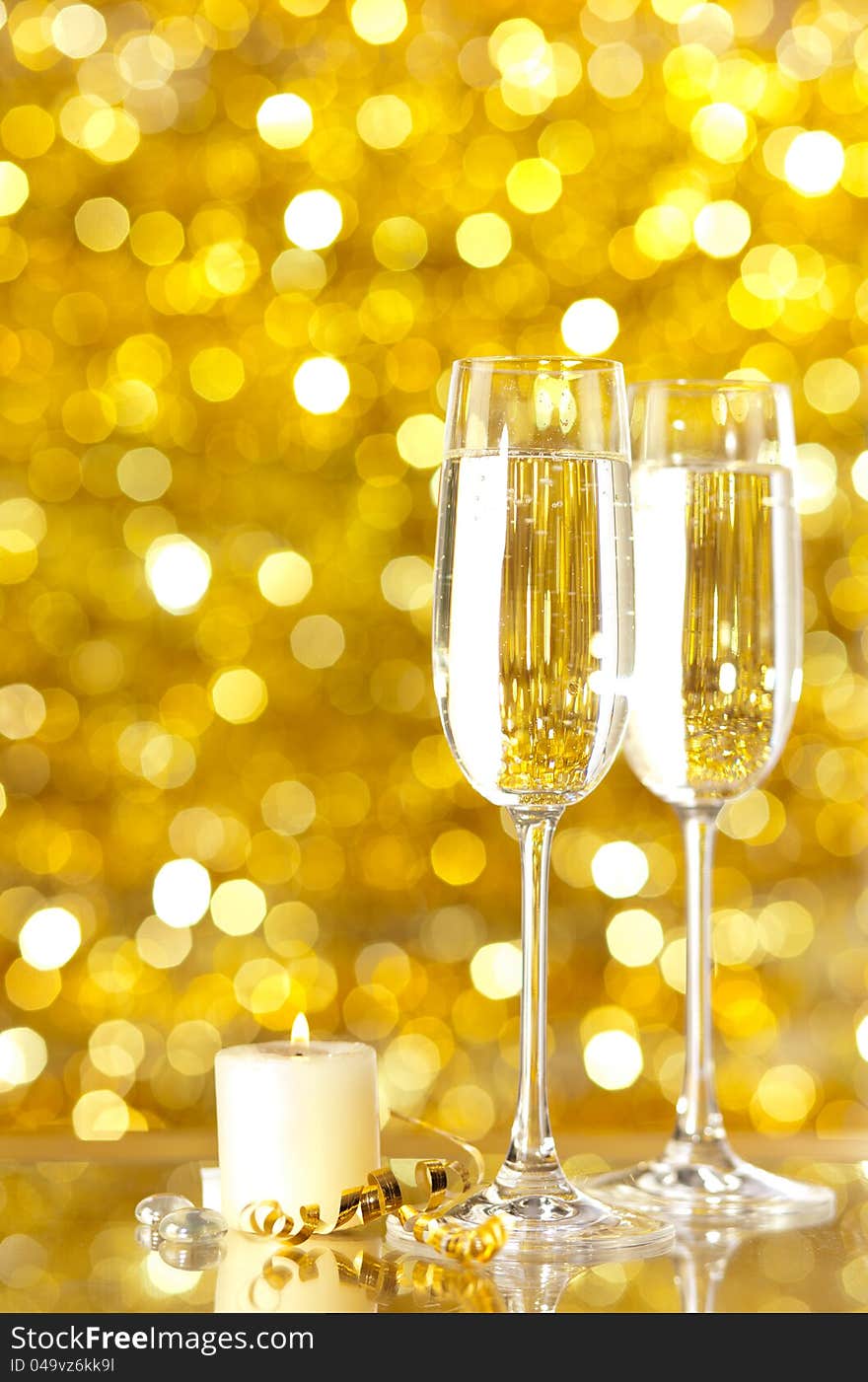 Two glasses of champagne with lights in the background. very shallow depth of field, focus on near glass.