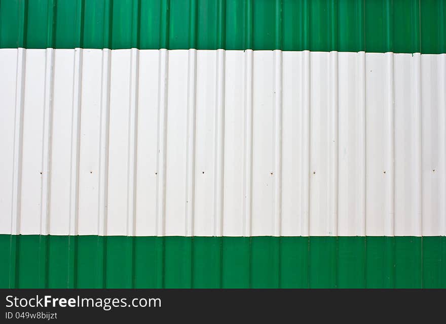 Corrugated steel sheet useful as a background paint white and green