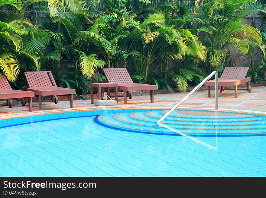 Wooden pool trestle beds by the poolside