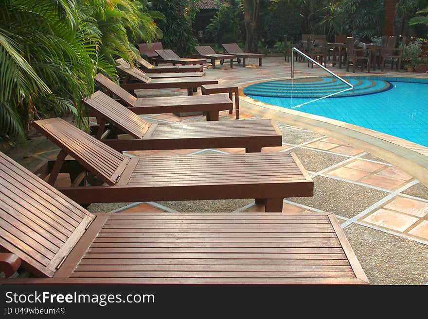 Wooden pool trestle beds by the poolside